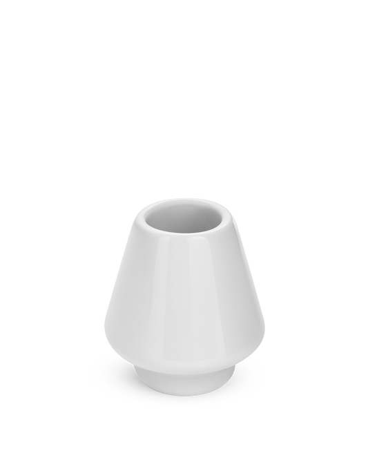 A small, matte white Fellow Matcha Set Whisk Holder with a wide base and narrow opening.