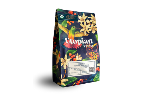 A vibrant Obsidian bag by Utopian Coffee with Latin American beans, florals, birds, and butterflies.
