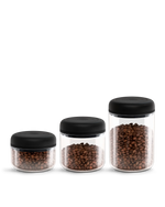 Fellow Atmos Vacuum Canister 3 Pack stores coffee beans in clear jars with black lids.